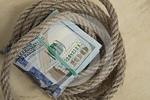 Hostage buyout concept image. Money dollars and rope