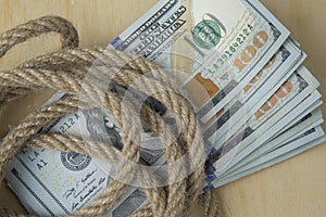 Hostage buyout concept image. Money dollars and rope photo