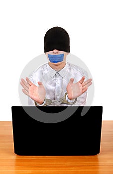 Hostage in Handcuffs behind Laptop