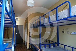 Hostel dormitory beds arranged in dorm room