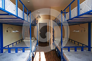Hostel dormitory beds arranged in dorm room