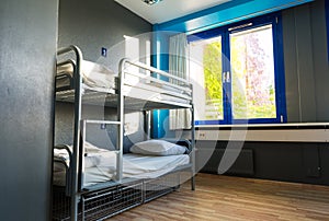 Hostel interior, metal bunk beds and linen, nobody