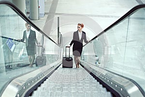 Hostess on escalator in airport