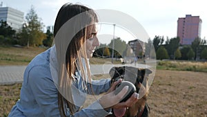 The hostess plays with the dog. The mistress caresses the dog. happy woman dog breeder walking with the dog.slow motion