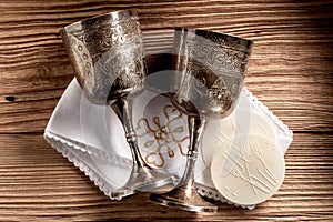 Hostie wafers with silver chalice cups and cloth