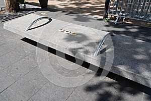 Hostile architecture defensive bench with metal armrests designed to stop people laying down sitting in street france Antibes city