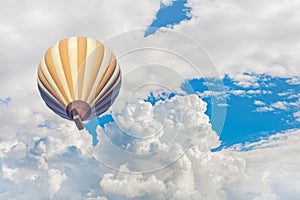 Hot air balloon with blue cloudy sky background