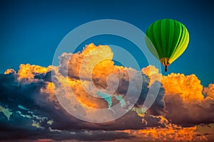 Hot air balloon with cloudy dramatic sunset background