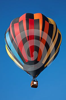 Hot air balloon, colorful aerostat on clear blue sky