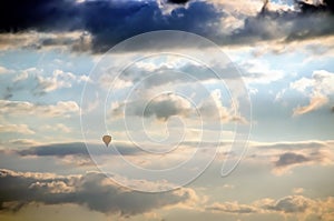 Hot air balloon in flight against dramatic cloudy sky