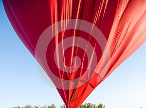 Hot air balloon floating in the sky big red hot air balloon in the shape of a big heart for love and world peace