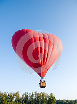 Hot air balloon floating in the sky big red hot air balloon in the shape of a big heart for love and world peace