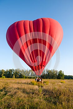 Hot air balloon floating in the sky big red hot air balloon in the shape of a big heart for love and world peace