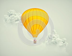 Hot air balloon flying above clouds