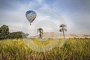Hot air balloon flying over Luxor west bank photo