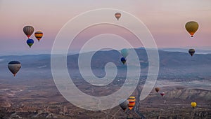 Hot air balloon flying over spectacular Cappadocia, Tourists enjoy the overwhelming views over Cappadocia, Turkey