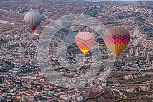 Hot air balloon flying over spectacular Cappadocia, Tourists enjoy the overwhelming views over Cappadocia, Turkey