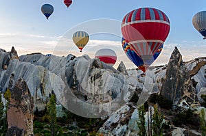 Hot air balloon flying over valleys in Cappadocia Turkey