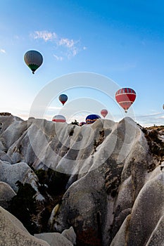 Hot air balloon flying over valleys in Cappadocia Turkey