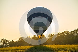 Hot air balloon flying at sunset.