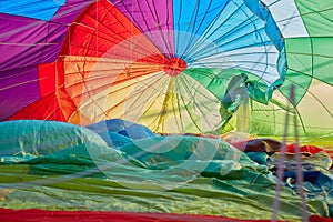 Hot air balloon inflating inside view, man shadow