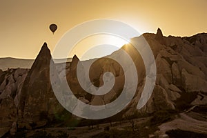 Hot air balloon over landscape of Cappagocia in Turkey