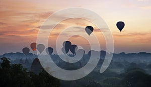 Hot air balloon over plain of Bagan in misty morning, Magical sunrise over the temples in Bagan, Myanmar.