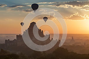 Hot air balloon over plain of Bagan in misty morning, Myanmar