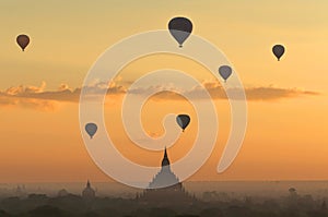 Hot air balloon over plain of Bagan in misty morning, Myanmar