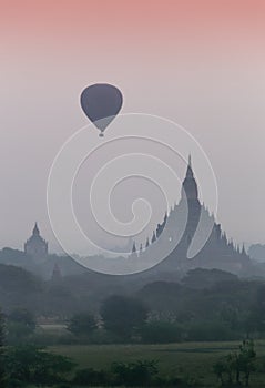 Hot air balloon over plain of Bagan in misty morning, Myanmar