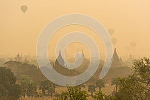 Hot air balloon over plain of Bagan in misty morning before sunrise, Myanmar