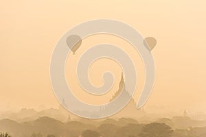 Hot air balloon over plain of Bagan in misty morning before sunrise, Myanmar