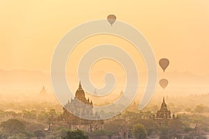 Hot air balloon over plain of Bagan in misty morning before sunrise, Myanmar