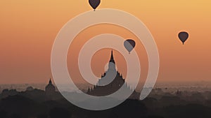 Hot air balloon over plain of Bagan at sunrise, Myanmar