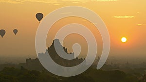 Hot air balloon over plain of Bagan at sunrise, Myanmar