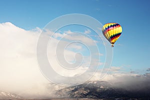 Hot Air Balloon Over Snowy Mountain