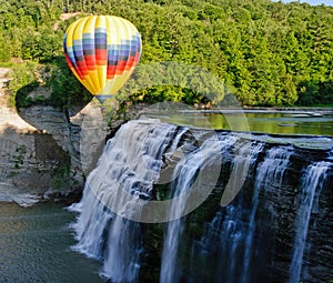 Hot air balloon over waterfall