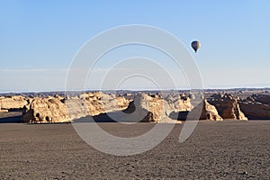 Hot air balloon over yardang landforms