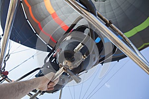 Hot air balloon pilot operating the burners