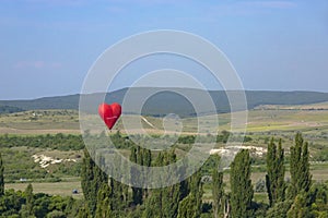 Hot air balloon, Red balloon in the shape of a flying heart against the background of the White Rock
