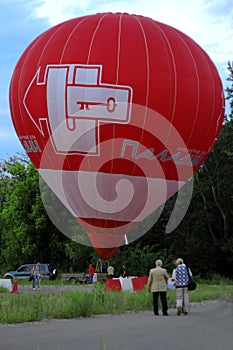 Hot air balloon starting to fly in evening sky