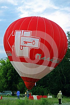 Hot air balloon starting to fly in evening sky