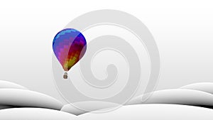 Hot air balloon with vivid colors and geometric designs flying from the bottom up behind white geometric mountains
