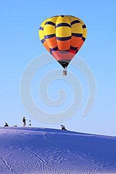Hot air balloon and white sand dune