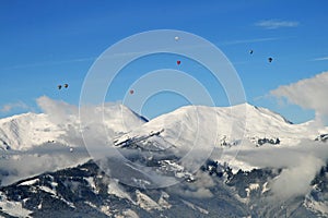 Hot air ballooning over the tops of mountains photo