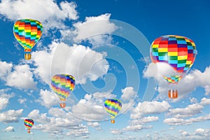 Hot air balloons on clouds in blue sky