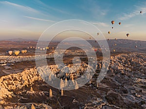 hot air balloons at fairy chimneys at sunrise in G reme, Cappadocia.