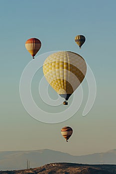 Hot air balloons festival in blue sky in Goreme national park, fairy chimneys,