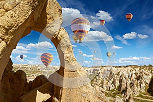 Hot air balloons flies in blue sky in Kapadokya, Turkey