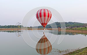 Hot air balloons flight over lake.